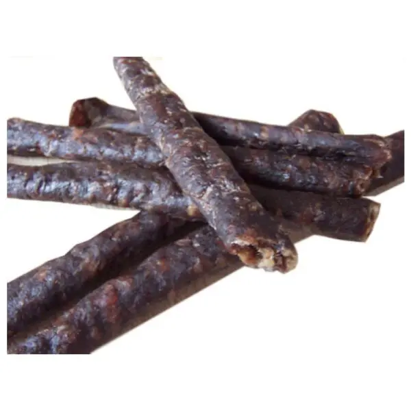 A pile of dark, dried biltong biersticks arranged in a scattered manner.