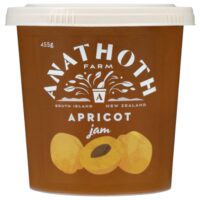 Tub of Anathoth Farm apricot jam with a label featuring apricot illustrations.