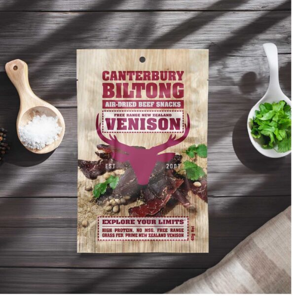 Pack of Canterbury Biltong air-dried venison snacks with a wooden background.