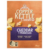 Packaged Copper Kettle crackers featuring cheddar and parmesan flavours, weighing 135 grams.